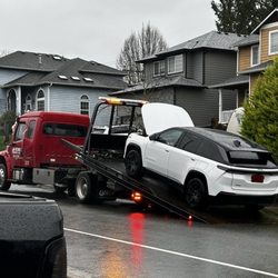 A wish towing - Tow truck and my vehicle being loaded on it.