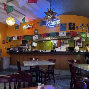 Sazón - a restaurant with tables, chairs, and a bar - Mexican Near Me - Austin, Texas