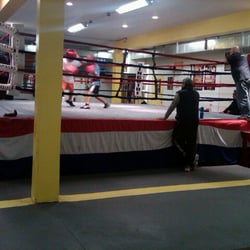Chicago Youth Boxing Club - A coach offers feedback while a parent observes his son's sparring match.