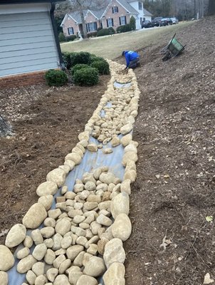 Stone Lined Runoff - More than just landscaping services, we also offer a variety of services. From drainage, aeration, flower bed installations and landscape design. We are your one stop shop for all lawn care needs!