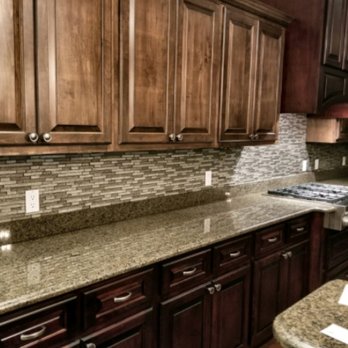 Romanoff Renovations - a kitchen with dark wood cabinets and granite countertops - Flooring Near Me - Homewood, Alabama Romanoff Renovations - a kitchen with dark wood cabinets and granite countertops - Flooring Near Me - Homewood, Alabama