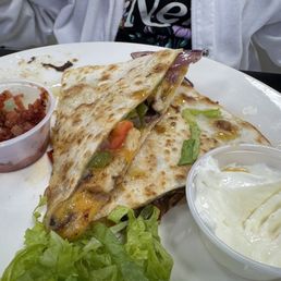 Half eaten delicious chicken quesadilla Half eaten delicious chicken quesadilla