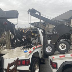 Abbotsford Mobile Mechanics - Working on replacing hydraulic lines on a tow truck by lifting the hydraulic winch off with another tow truck.