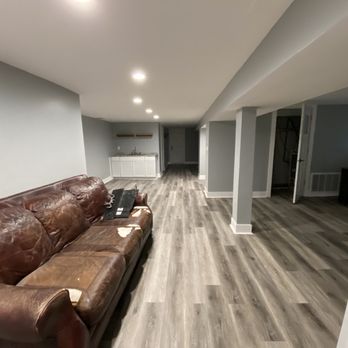 Global Home Improvement - New drywall, paint, baseboards, and vinyl flooring. Sorry for old couch. - General Contractors Near Me