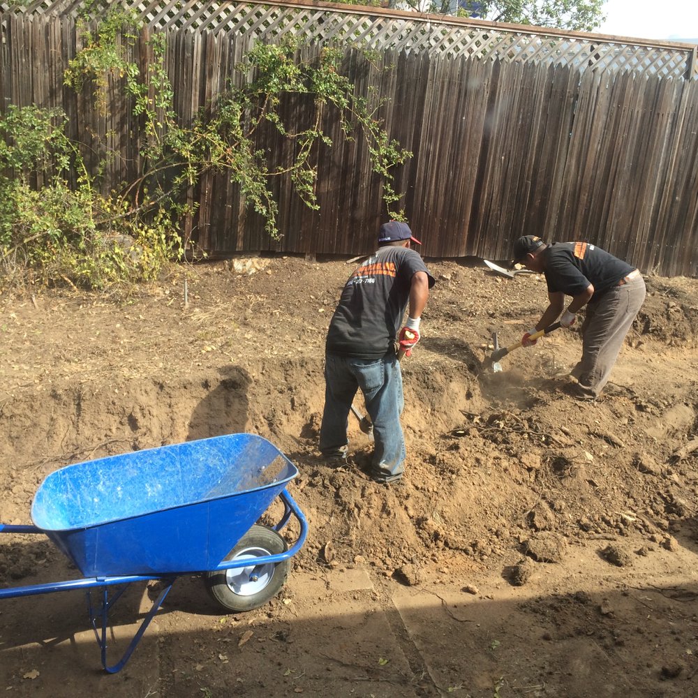 Rhino's Construction - Rhino's crew working hard to get rid of lots of dirt and the tree stump behind the old retaining wall - Landscaping Near Me Rhino's Construction - Rhino's crew working hard to get rid of lots of dirt and the tree stump behind the old retaining wall - Landscaping Near Me