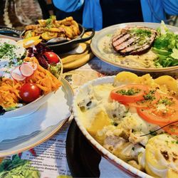 Wittenberger Kartoffelhaus Zum Schwarzer Baer - Foreground right: Potato casserole with pork filet strips. Foreground left: Big Salad. Background right: Ham, Creamy Sauerkraut. And more.