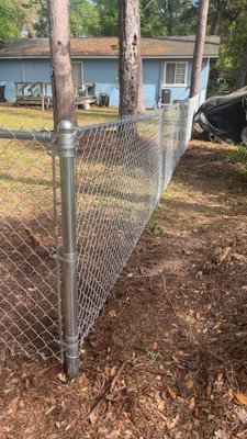 Chain-link fence - Once this fence goes up, you never have to think about it again. It won't rot from rain, it won't warp in the sun, and termites can't eat it. There is no staining, no sanding, and no weekend yard work required. It just works, year after year. Chain-link fence - Once this fence goes up, you never have to think about it again. It won't rot from rain, it won't warp in the sun, and termites can't eat it. There is no staining, no sanding, and no weekend yard work required. It just works, year after year.