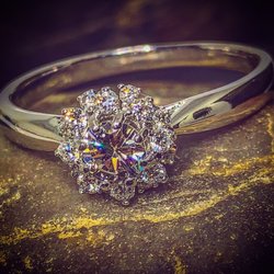 J.P. Haase Jewelers - Customer supplied center diamond for this cute cluster engagement ring.
