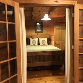 Cottages At Spring House Farm - French doors to the bedroom from the sunroom, directly across from the wood burning stove - Hotels Near Me - Marion, North Carolina
