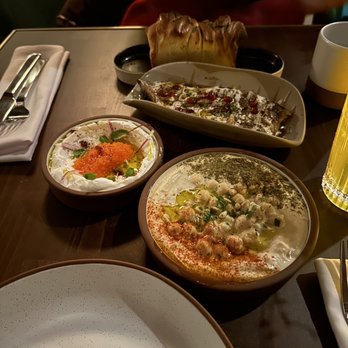 Anixi - 3 dip mezze - Layered Herb Bread (top) with Taramasalata (left), Fire Roasted Eggplant (middle), and Hummus Masabacha (bottom) - Vegan Near Me - New York, New York