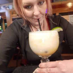 a woman drinking a margarita a woman drinking a margarita