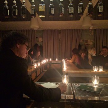 Big In Japan - Bottles on the ceiling and bottles on the table - Speakeasies Near Me - Montreal, Quebec