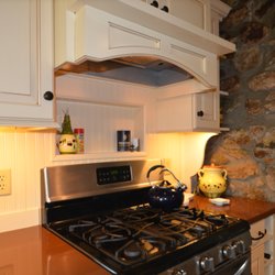 Custom ventialation and hood, with wainscot backsplash with niche.