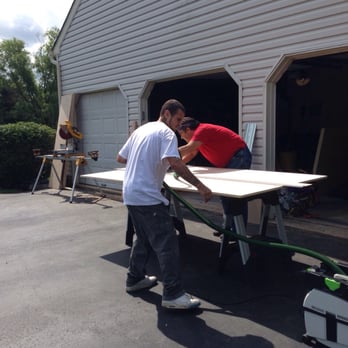 Tucker Construction Designs - two men working on a surfboard - General Contractors Near Me - Hamilton, New Jersey Tucker Construction Designs - two men working on a surfboard - General Contractors Near Me - Hamilton, New Jersey
