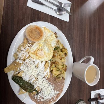 Rodeo Cafe - Chilaquiles verdes w/ 2 Two Eggs (Your Way), Rodeo Potatoes, refried beans, a roasted jalapeño and a cup of Coffee. - Breakfast & Brunch Near Me - Rialto, California Rodeo Cafe - Chilaquiles verdes w/ 2 Two Eggs (Your Way), Rodeo Potatoes, refried beans, a roasted jalapeño and a cup of Coffee. - Breakfast & Brunch Near Me - Rialto, California