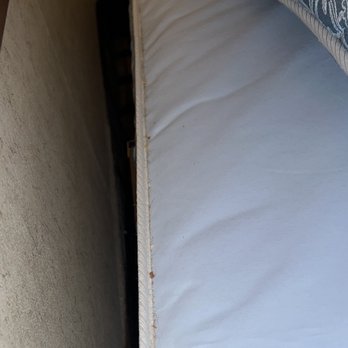 Quality Inn - Look at all the dirt and hair and food in the crease of the mattress below the headboard. - Hotels Near Me - Raton, New Mexico