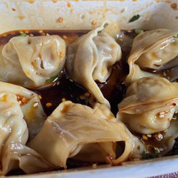 Pot Sticker Dumpling House - Shrimp and pork wontons in tangy sauce. Eight per order...I added the chili flakes.