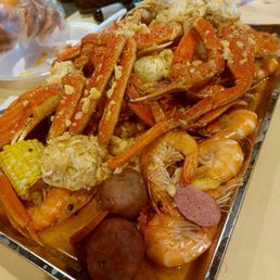 Snow crab legs, whole shrimp, and blue crab