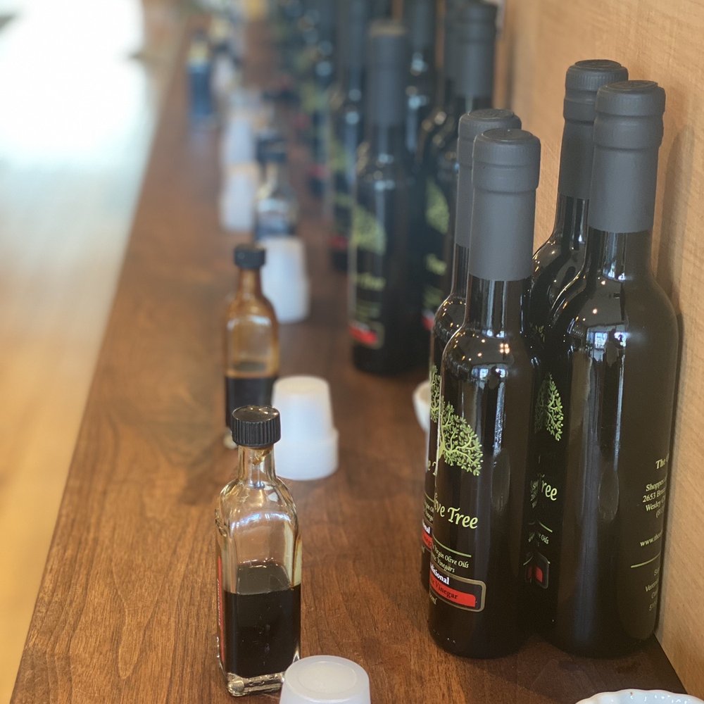 The Olive Tree - a row of bottles of olive oil - Olive Oil Near Me - Wesley Chapel, Florida The Olive Tree - a row of bottles of olive oil - Olive Oil Near Me - Wesley Chapel, Florida