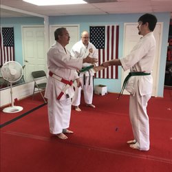 Freeman's Shorin-Ryu Karate - Student accepting new belt ranking from Master Kyoshi