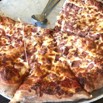 Vulcano - a pizza on a pan with a spatula - Italian Near Me - Mascouche, Quebec Vulcano - a pizza on a pan with a spatula - Italian Near Me - Mascouche, Quebec