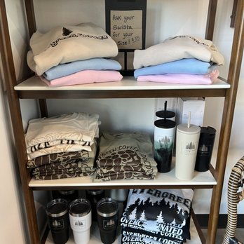 Evergreen Coffee - a shelf full of coffee mugs and blankets - Coffee & Tea Near Me - Owasso, Oklahoma