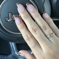 Deluxury Nail & Spa - Base is bubble bath Brown curved French is 53 With white lining detail Thank you Kelly!!
