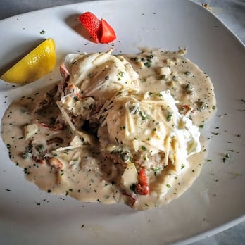 Half Shell Oyster House - Crab cake topped with egg and cream sauce - Seafood Near Me - Biloxi, Mississippi Half Shell Oyster House - Crab cake topped with egg and cream sauce - Seafood Near Me - Biloxi, Mississippi