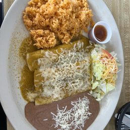 Enchiladas verdes (three) with rice and refried beans. Enchiladas verdes (three) with rice and refried beans.