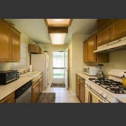 a kitchen with a stove, refrigerator, microwave, and dishwasher