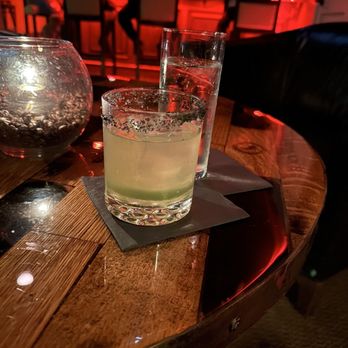 Black Rabbit - a drink in a glass on a wooden table - Lounges Near Me - Louisville, Kentucky