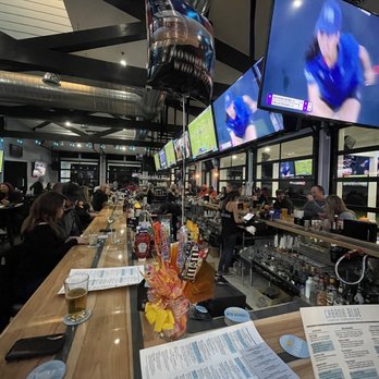 Cabana Blue - people sitting at a bar watching televisions - Sports Bars Near Me - Clay Township, Michigan
