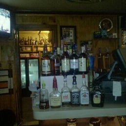 a bar with liquor bottles on a counter a bar with liquor bottles on a counter