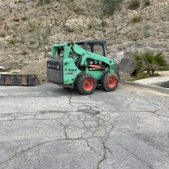 M2 Operating - a skid steer loader in a parking lot - General Contractors Near Me - Los Angeles , California M2 Operating - a skid steer loader in a parking lot - General Contractors Near Me - Los Angeles , California