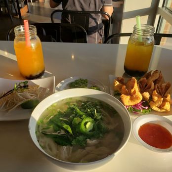 Pho Please - Chicken pho with rice noodles and crab rangoon and boba peach fruit tea on the left and a boba passion fruit tea on the right - Vietnamese Near Me - Austin, Texas