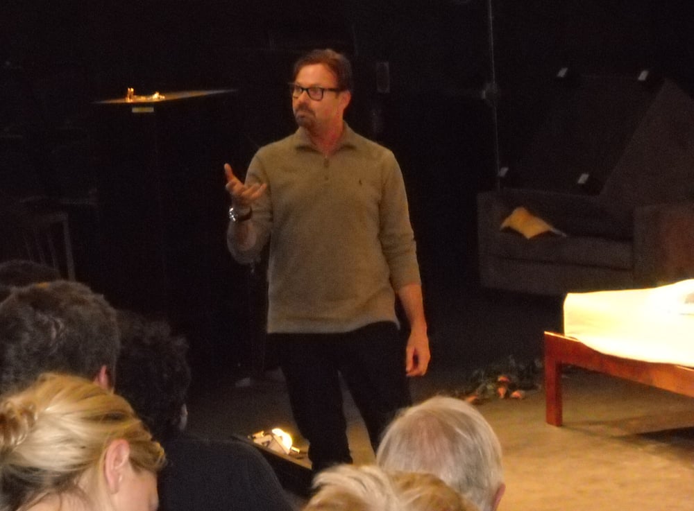 Howard on the floor with actors giving feedback, adjustments and in