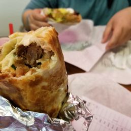 Photo of La Taqueria - San Francisco, CA, United States. What's left of my Carnitas Burrito Dorado...Taco Dorado in the background