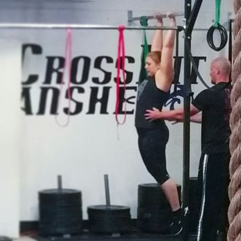LMI Fitness - From the base level, coach and member progressing to a kipping pull-up. - Gyms Near Me - Aurora, Colorado LMI Fitness - From the base level, coach and member progressing to a kipping pull-up. - Gyms Near Me - Aurora, Colorado