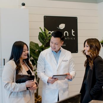 Mint Orthodontics - Dr. T discussing with his front office team - Orthodontists Near Me - Irvine, California Mint Orthodontics - Dr. T discussing with his front office team - Orthodontists Near Me - Irvine, California