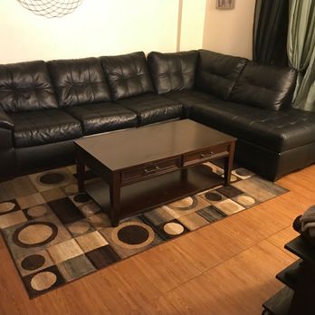 Angels Forever - a living room with black leather furniture - Handyman Near Me - Eastchester, New York