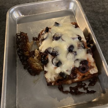 Black Mountain Kitchen & Ale House - Detroit pizza slice with Kalamata olives - Comfort Food Near Me - Black Mountain, North Carolina Black Mountain Kitchen & Ale House - Detroit pizza slice with Kalamata olives - Comfort Food Near Me - Black Mountain, North Carolina