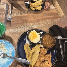 Half and half fish and shrimp with cheese grits and baked beans Also pictured kids fish with Mac n cheese Half and half fish and shrimp with cheese grits and baked beans Also pictured kids fish with Mac n cheese