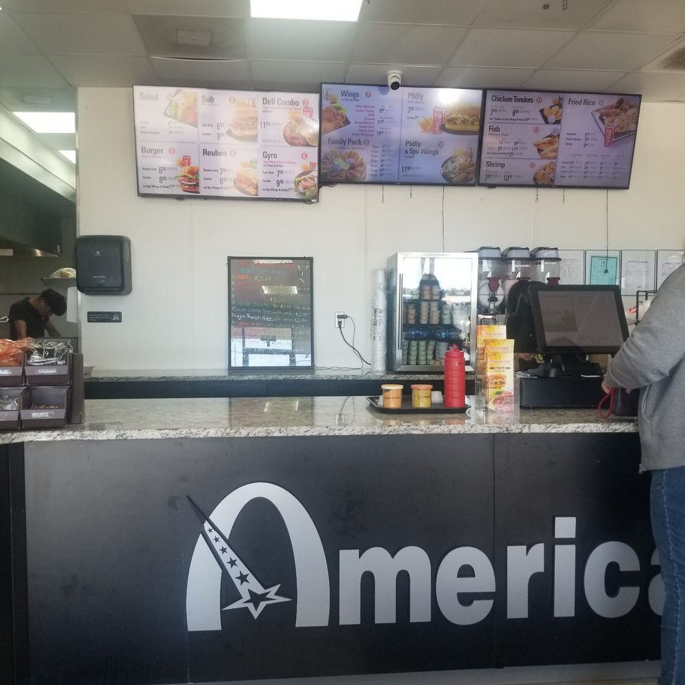 American Deli - a man standing at the counter - Chicken Wings Near Me - Phenix City, Alabama