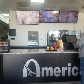 American Deli - a man standing at the counter - Chicken Wings Near Me - Phenix City, Alabama