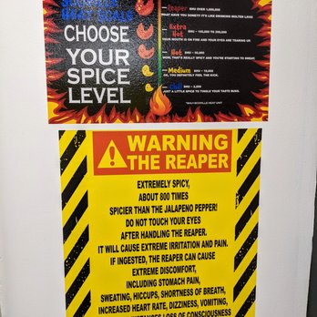 Scoville Hot Chicken - Inside. Warning sign about The Reaper. Spice level descriptions. - Burgers Near Me - Atlanta, Georgia