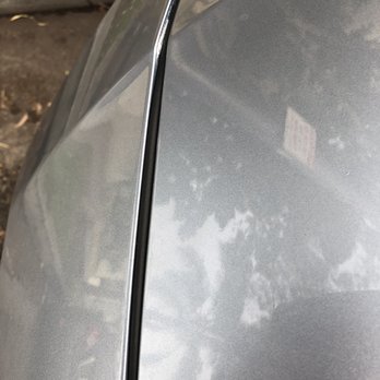 Caliber Collision - Front water seal on the hood above the hood line... but only on the left side. "Pinched" almost but can't be pushed to position - Body Shops Near Me - Long Beach, California