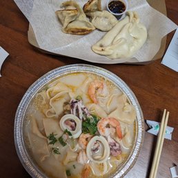 a bowl of soup and a plate of dumplings a bowl of soup and a plate of dumplings