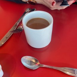 a cup of coffee and a spoon a cup of coffee and a spoon