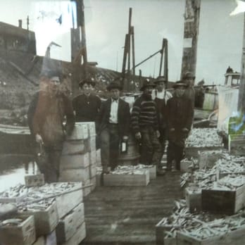 Gilmore Fish Smokehouse - a group of men standing on a dock - Smokehouse Near Me
