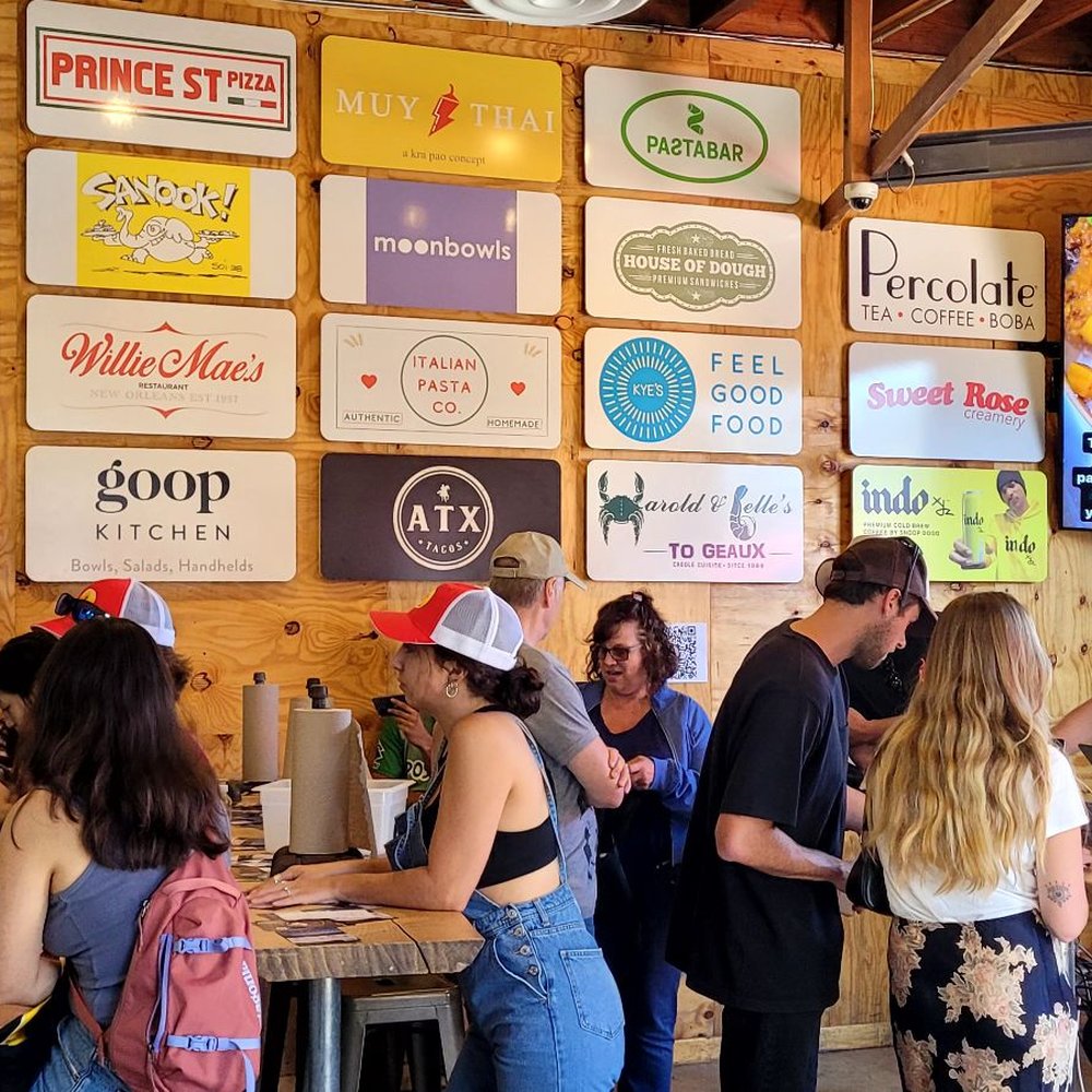 a large group of people standing in line a large group of people standing in line